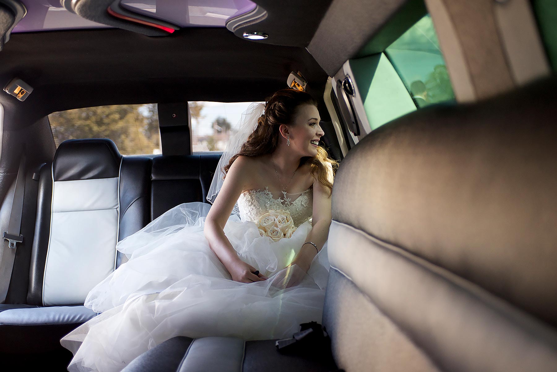 Young Bride sitting in her Limo right before wedding