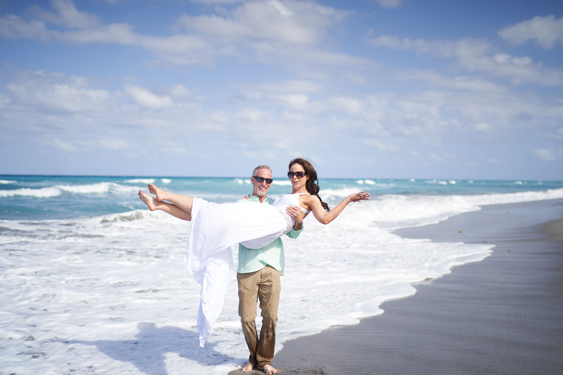 Spring-Bride-on-beach-in-arms-of-groom