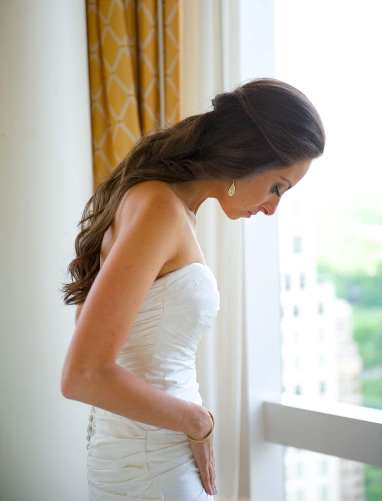 Young-Bride-Preparing-for-her-wedding-infront of window.