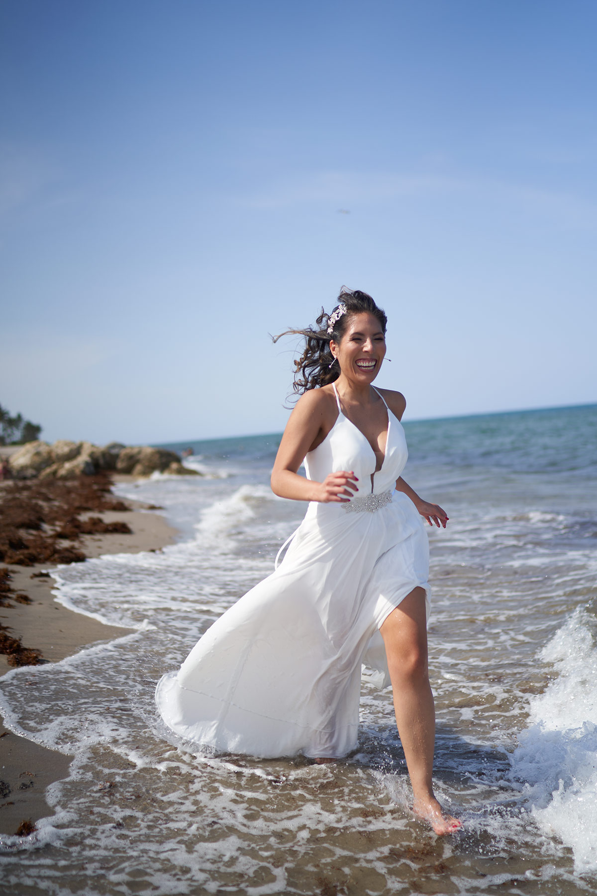 Young-Bride-running-along-Florida-Beach-on-her-wedding-day