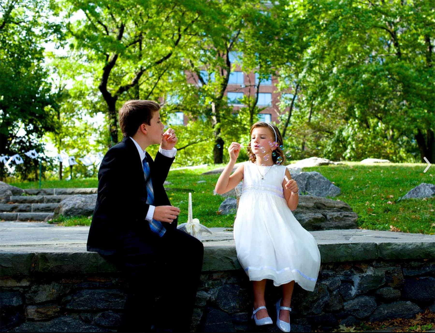 Young-Bridesmaid-blowing-bubbles-at-summer-wedding-in-Park